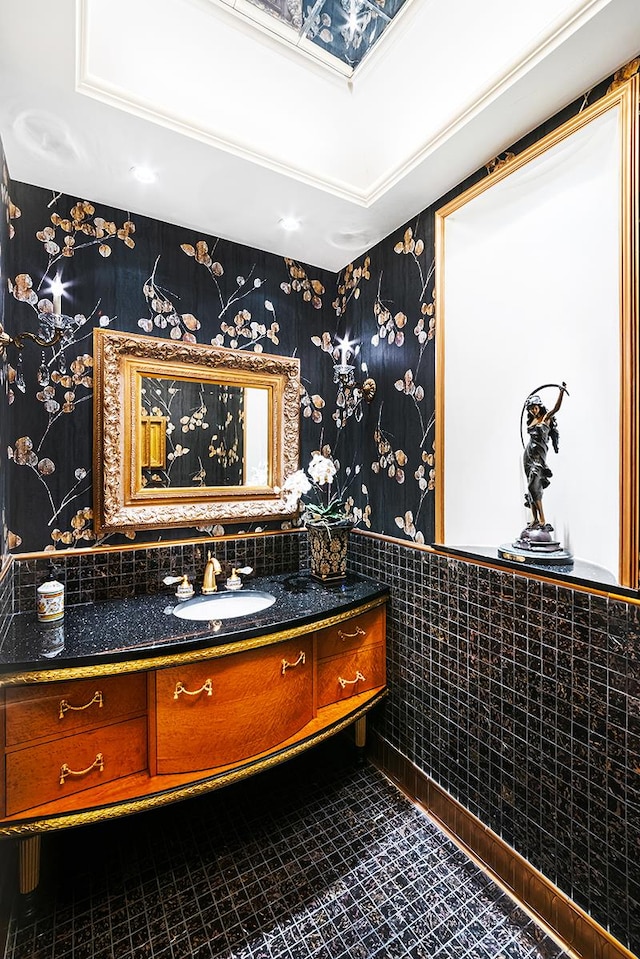 bathroom featuring tile patterned floors, a wainscoted wall, vanity, and wallpapered walls