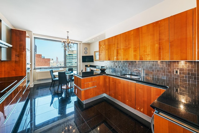 kitchen with granite finish floor, brown cabinets, modern cabinets, and a sink