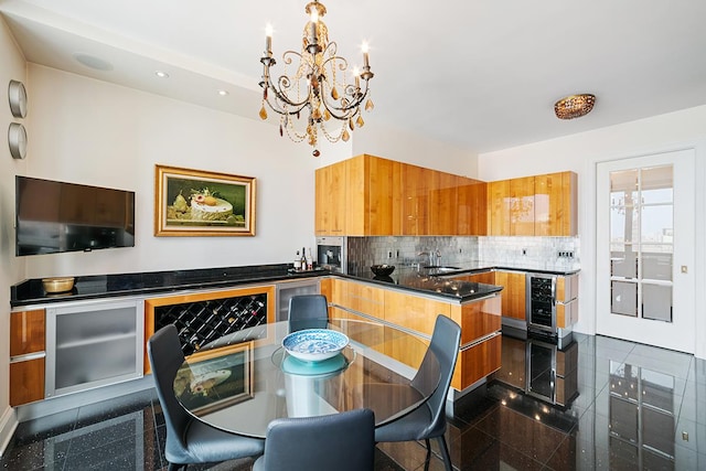 kitchen with modern cabinets, beverage cooler, granite finish floor, and brown cabinetry