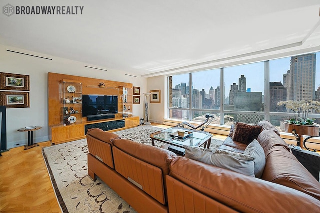 living area featuring expansive windows and baseboards