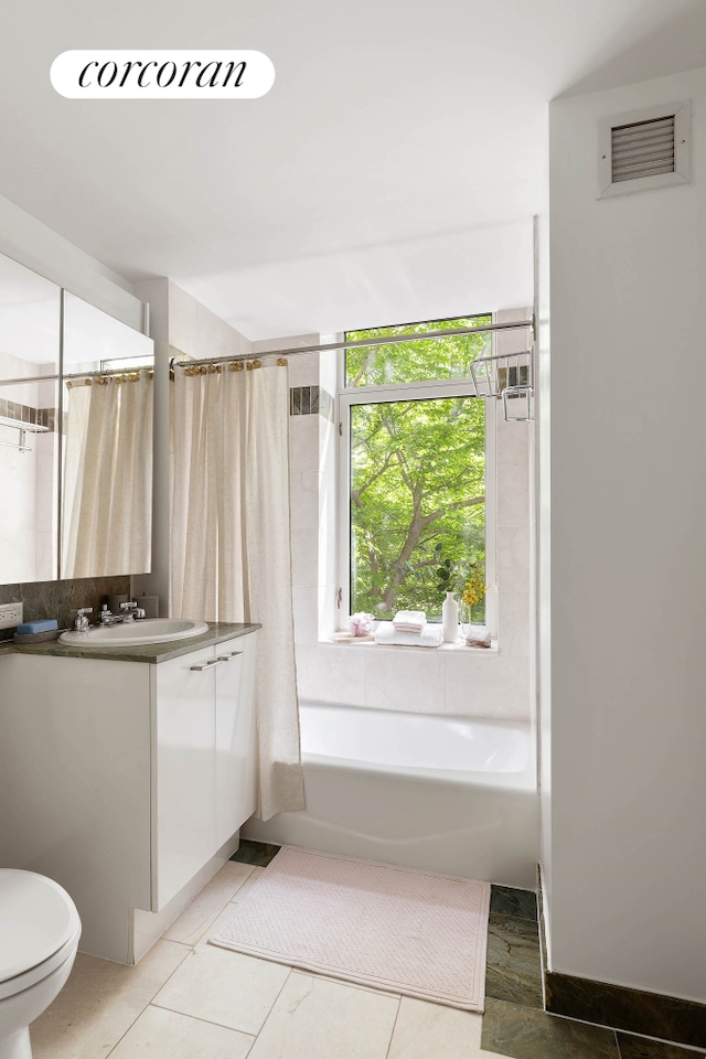 full bath featuring toilet, shower / bath combo with shower curtain, vanity, and visible vents