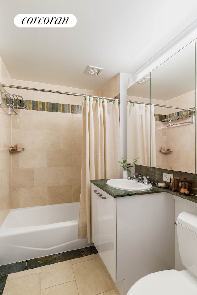 bathroom with toilet, shower / tub combo, visible vents, vanity, and tile patterned floors