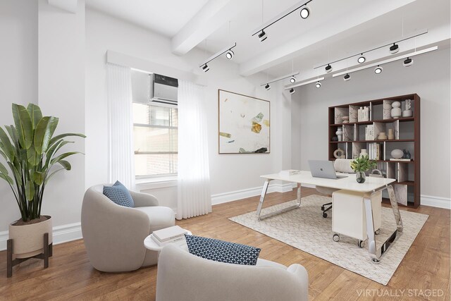 office featuring a wall mounted air conditioner, rail lighting, and hardwood / wood-style floors