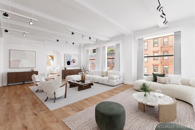 living room featuring beam ceiling, rail lighting, and light wood-type flooring