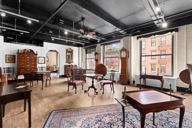 interior space with wood-type flooring, track lighting, and ceiling fan