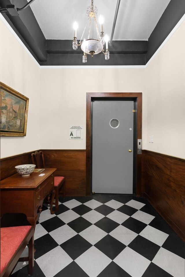 interior space featuring a notable chandelier and wood walls