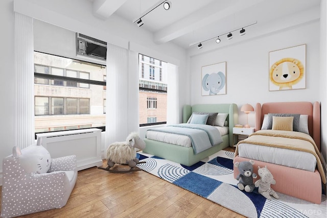 bedroom featuring beam ceiling, wood-type flooring, an AC wall unit, and rail lighting