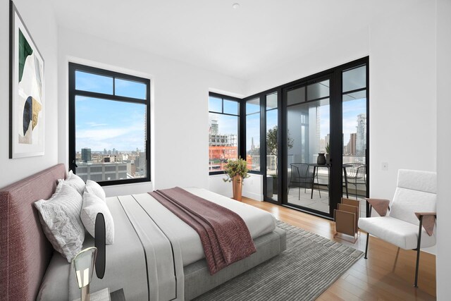 bedroom with wood-type flooring and access to exterior