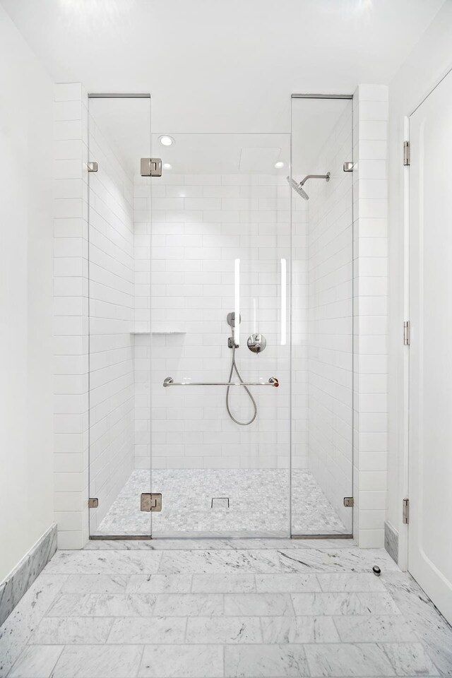 bathroom featuring a shower with door