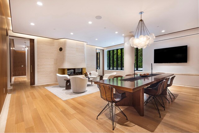 110 Charlton St Unit Ph30C, New York City, NY 10014 - dining space with light wood-style flooring, recessed lighting, and an inviting chandelier