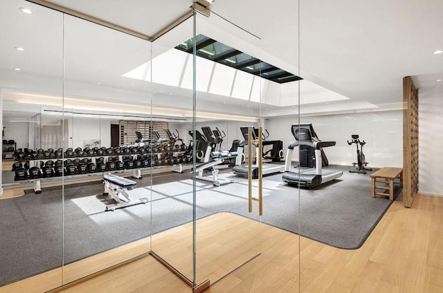 exercise room with hardwood / wood-style flooring