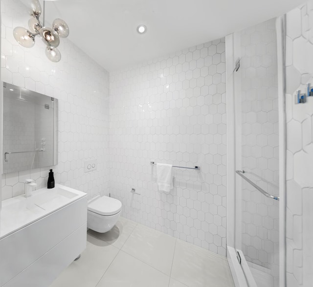 bathroom featuring toilet, tile patterned flooring, vanity, a shower stall, and tile walls