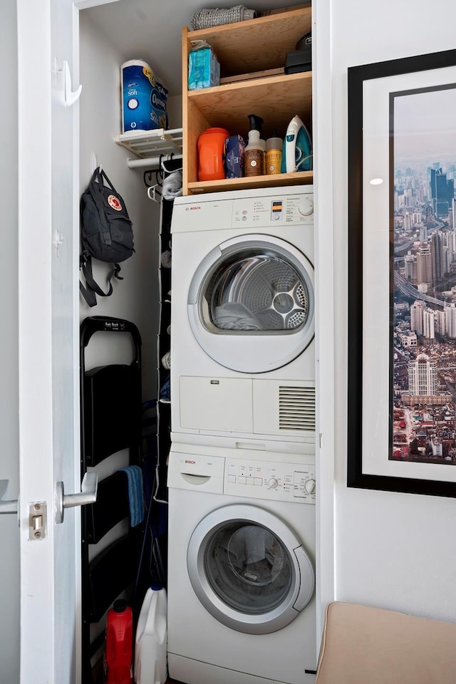 washroom featuring stacked washer and dryer