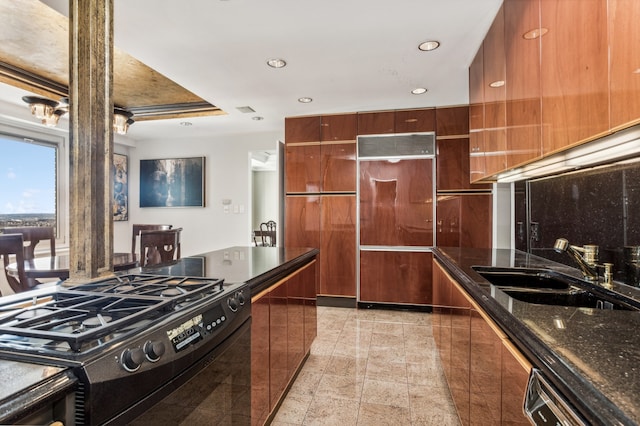 303 E 57th St Unit 45G, New York City, NY 10022 - kitchen featuring black gas range, a sink, modern cabinets, recessed lighting, and paneled fridge