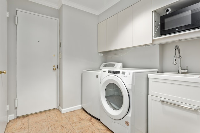 washroom featuring washer and dryer, a sink, cabinet space, crown molding, and baseboards