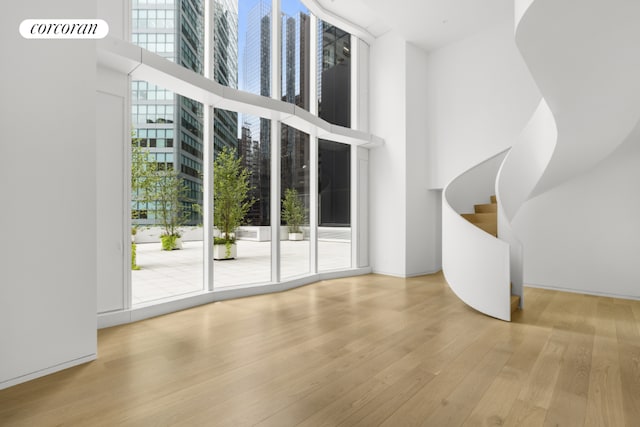 entryway featuring a towering ceiling and light hardwood / wood-style floors