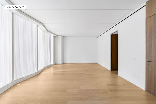 spare room featuring light hardwood / wood-style floors