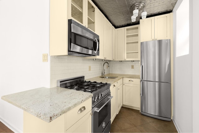 357 W End Ave Unit 3, New York City, NY 10024 - kitchen featuring stainless steel appliances, an ornate ceiling, a sink, tasteful backsplash, and light stone counters