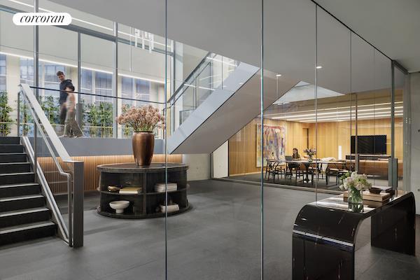 bathroom with a wall of windows, a bathtub, and hardwood / wood-style floors