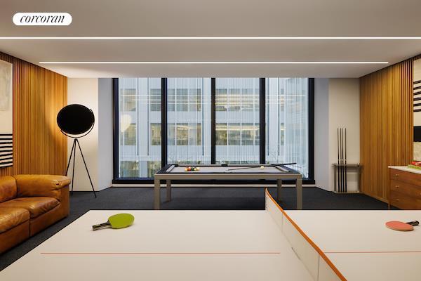 recreation room featuring wooden walls and dark carpet