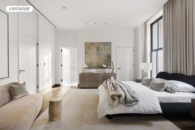 bedroom featuring visible vents and wood finished floors