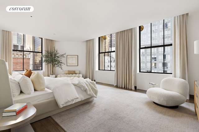 bedroom featuring visible vents and wood finished floors