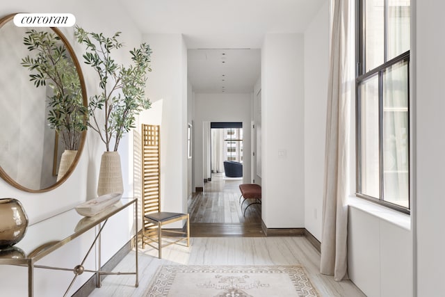 hallway with baseboards and wood finished floors