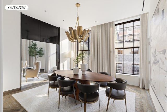 dining area with a wealth of natural light, visible vents, baseboards, and an inviting chandelier