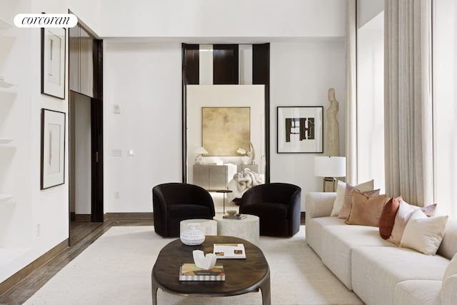 living room with baseboards and wood finished floors