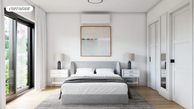 bedroom featuring light wood-type flooring, multiple windows, and a wall mounted air conditioner