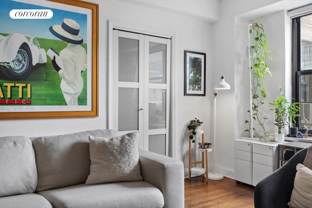interior space featuring baseboards and dark wood-style floors