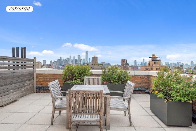 view of patio with a city view and outdoor dining space