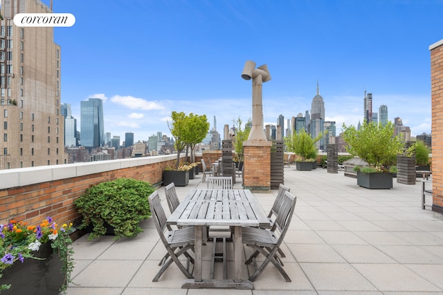 view of patio / terrace featuring a city view and outdoor dining area