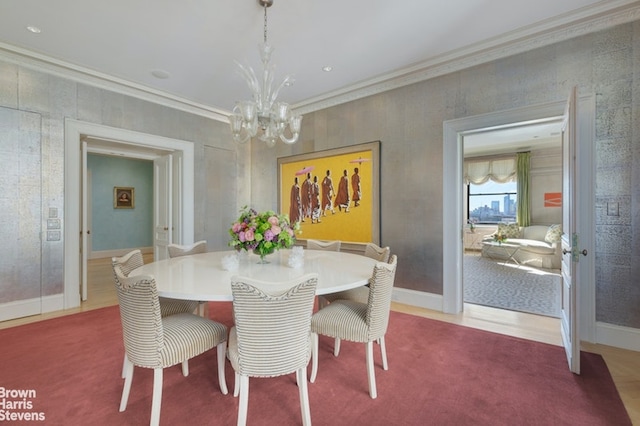 dining area with crown molding and a notable chandelier