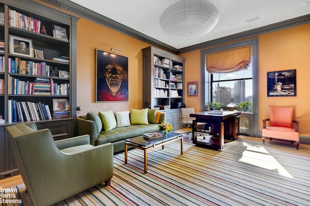 sitting room featuring crown molding