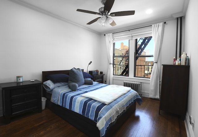 bedroom with dark wood-type flooring, ceiling fan, ornamental molding, and radiator