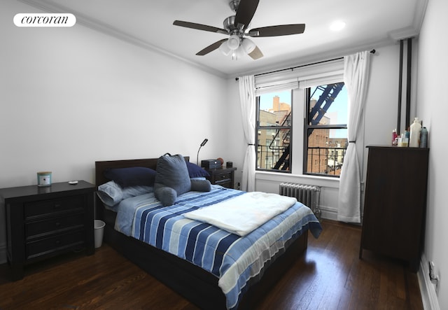 bedroom with radiator heating unit, ornamental molding, dark hardwood / wood-style floors, and ceiling fan