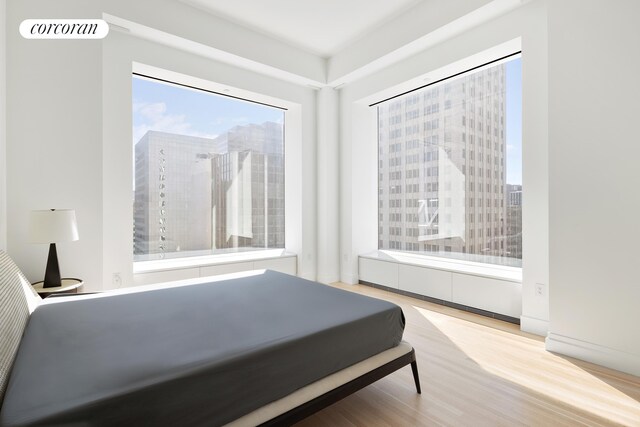 bedroom featuring hardwood / wood-style flooring and radiator