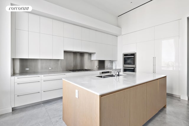 kitchen with white cabinetry, modern cabinets, appliances with stainless steel finishes, and a sink