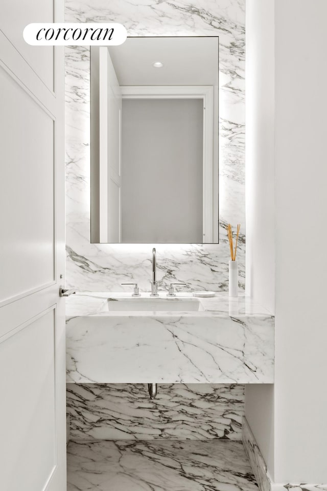 bathroom featuring stone wall