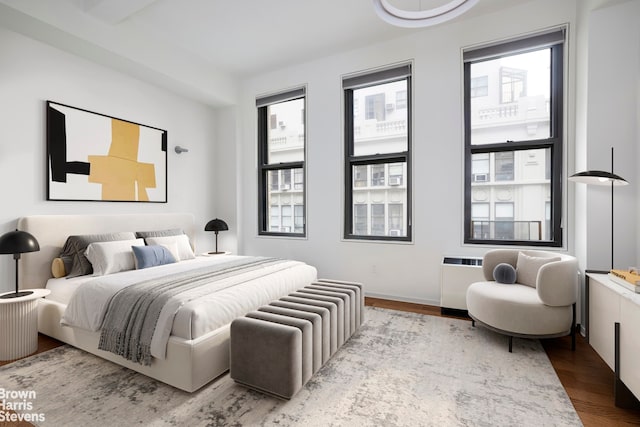 bedroom featuring multiple windows and light wood-type flooring