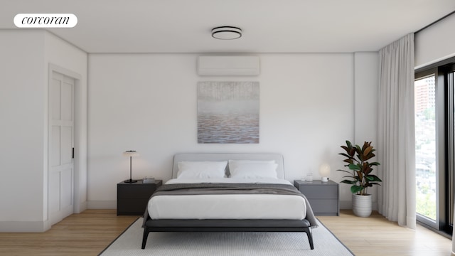 bedroom featuring a wall mounted AC and light hardwood / wood-style flooring