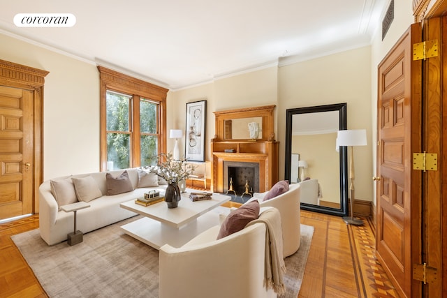 living area featuring a high end fireplace, visible vents, and ornamental molding