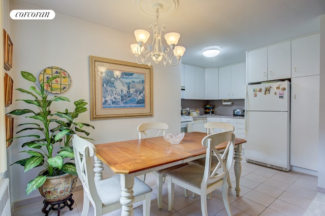 tiled dining space with radiator heating unit and a chandelier