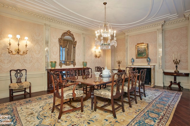 dining area featuring a notable chandelier, hardwood / wood-style flooring, and ornamental molding