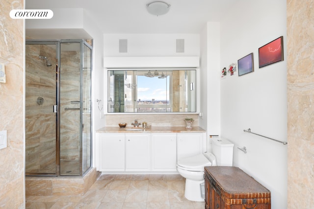 bathroom with toilet, vanity, and walk in shower