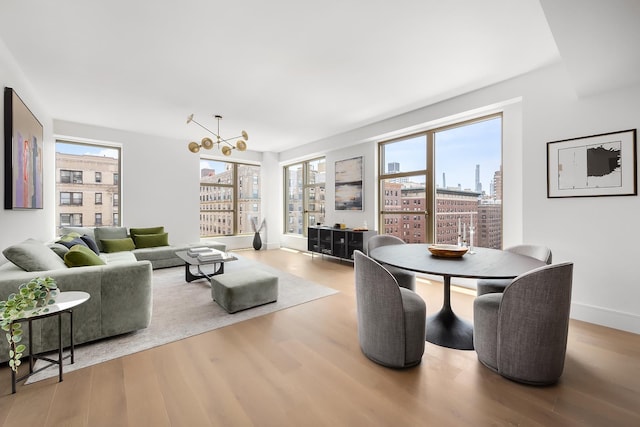 dining space with a view of city, baseboards, and wood finished floors