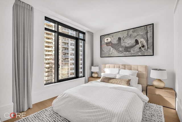 bedroom featuring multiple windows and light wood-type flooring