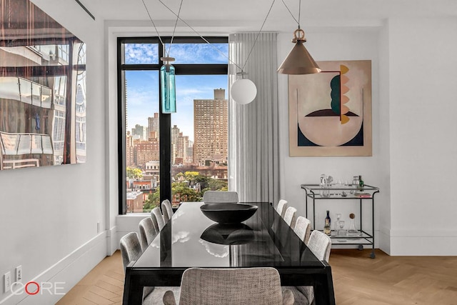 dining area featuring parquet flooring