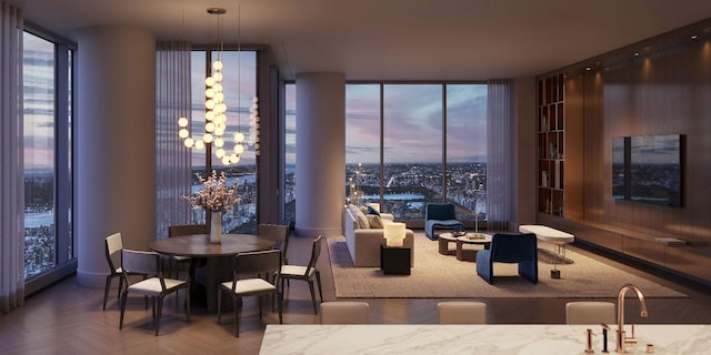 dining space with parquet floors, a wall of windows, a chandelier, and sink